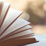 Book opened on white surface selective focus photography